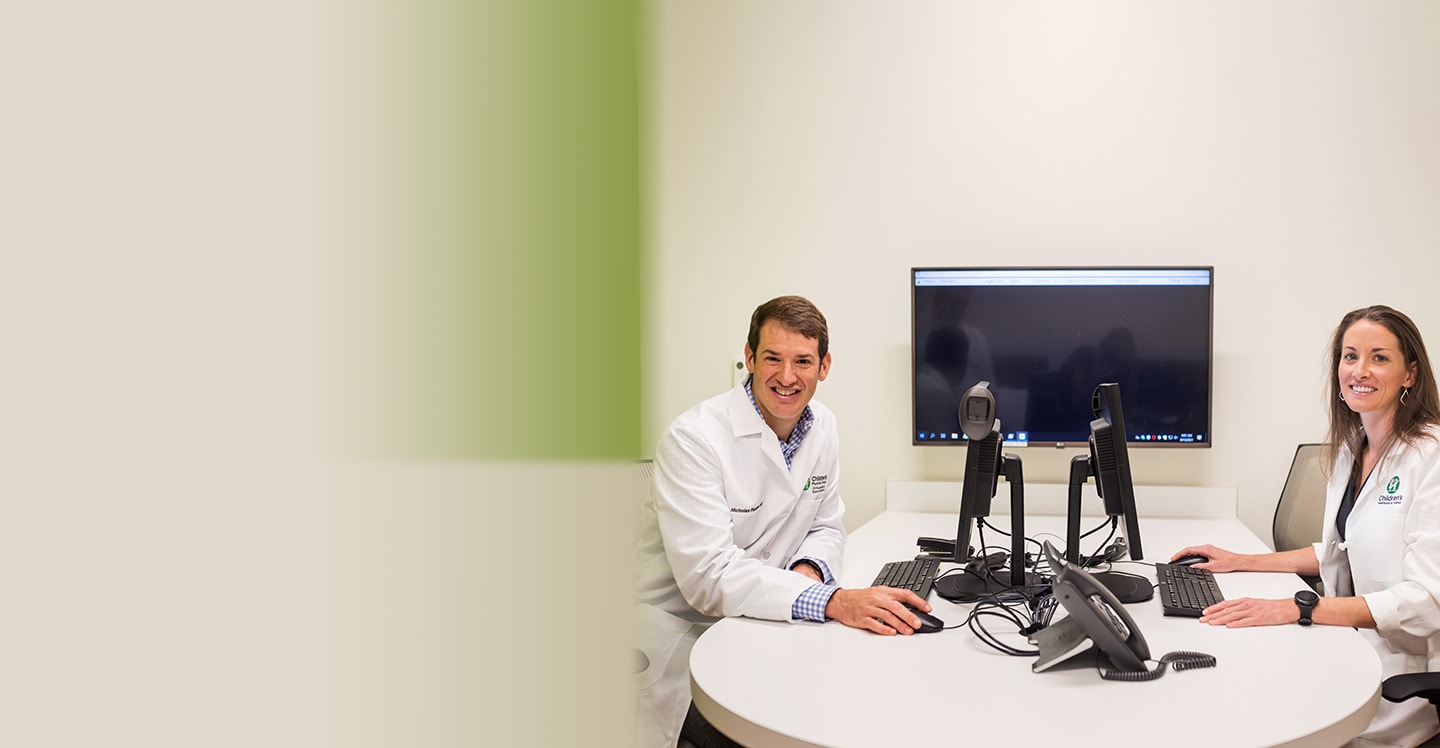 Ortho doctors Nick Fletcher and Crystal Perkins sitting at computer desk