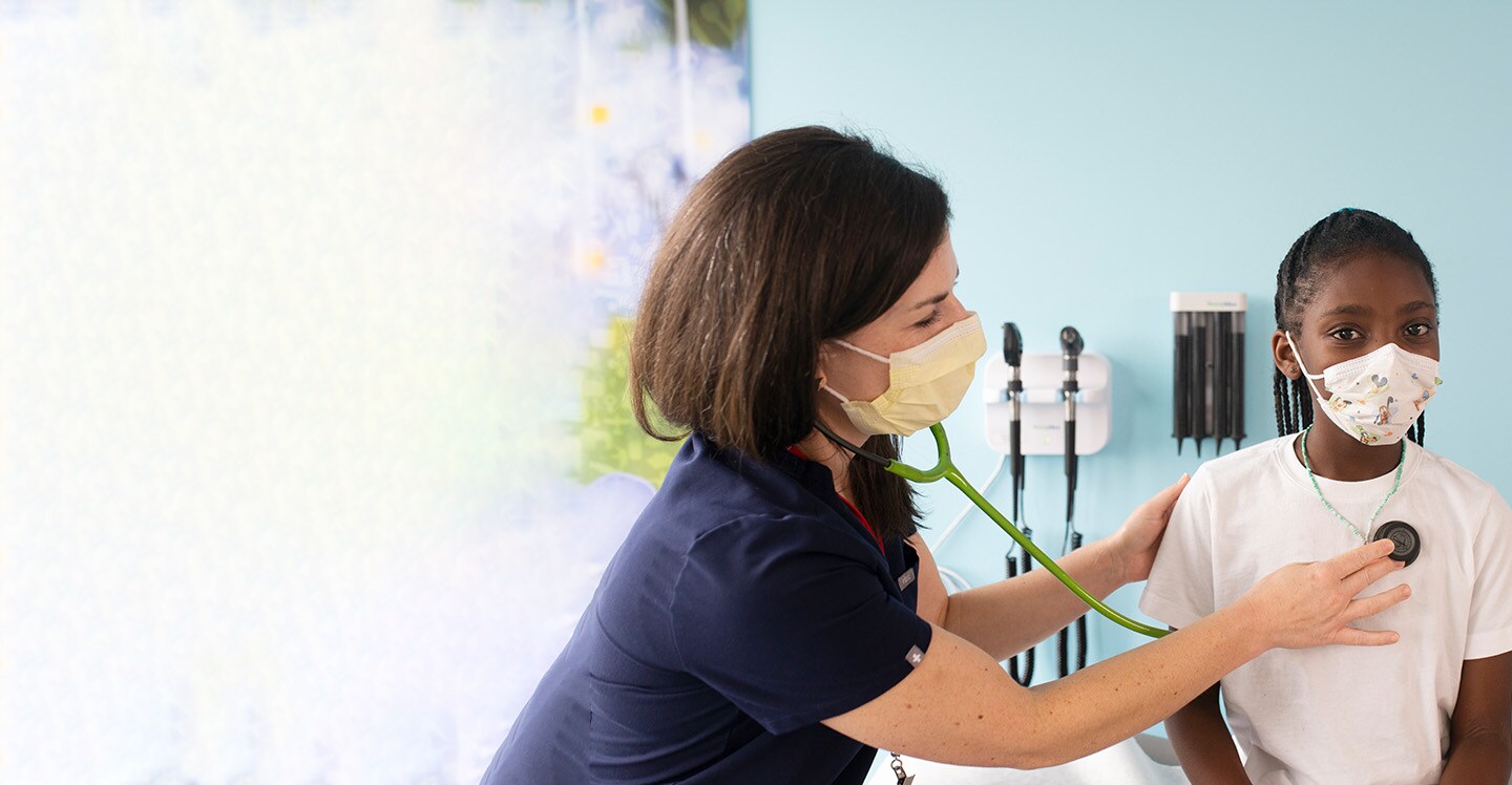 Children’s endocrinology nurse examining girl in clinic