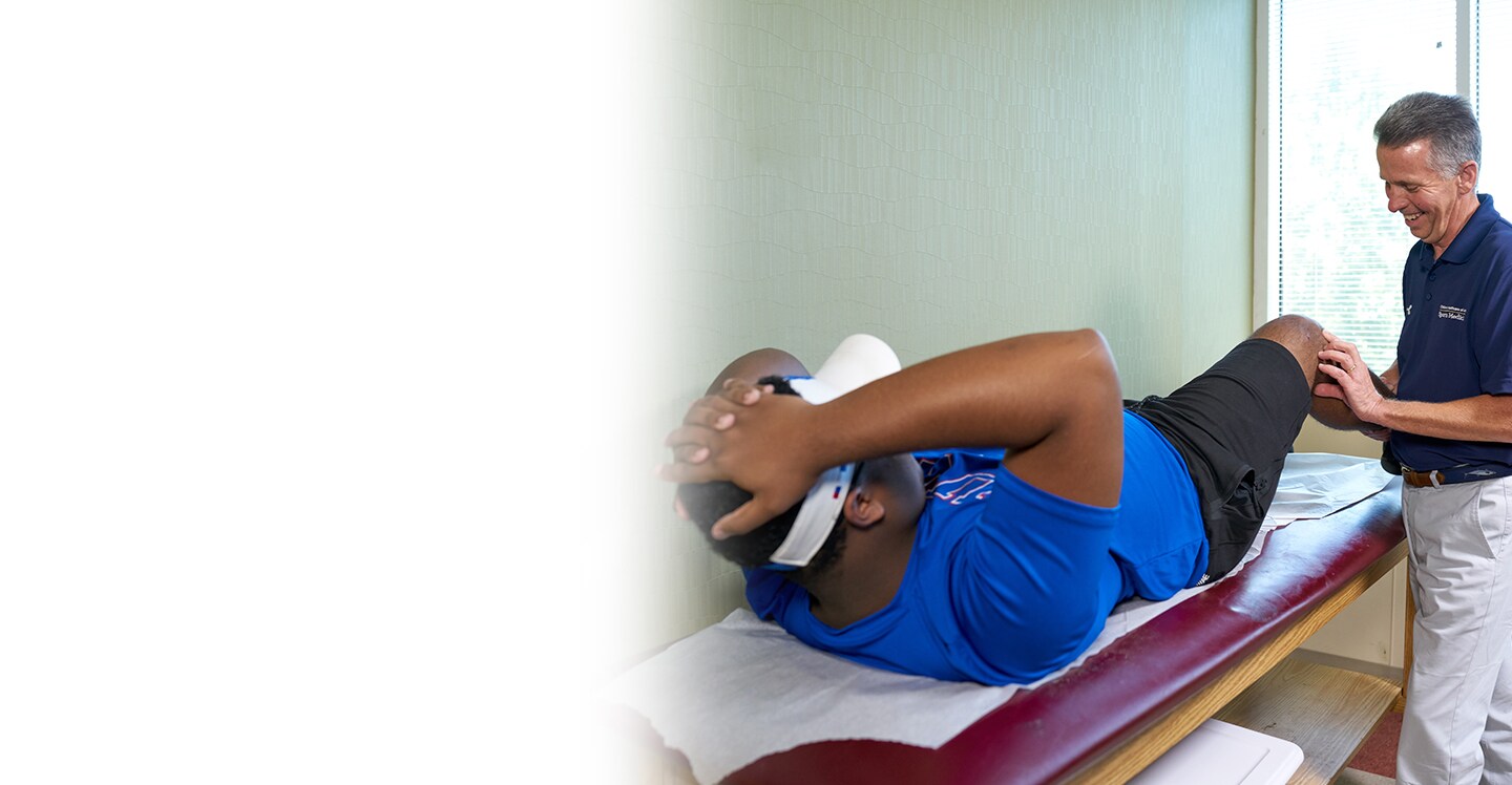 sports medicine physician examining a patient