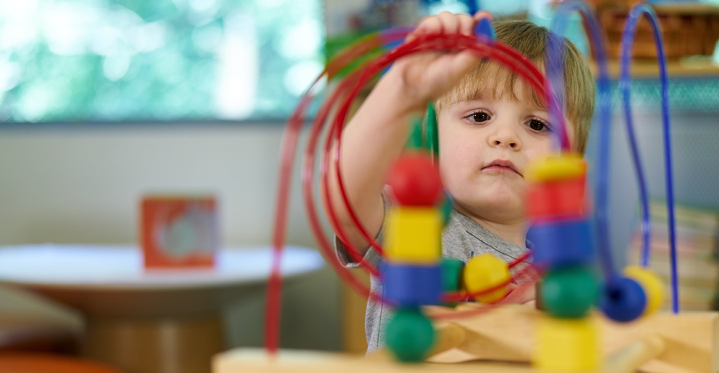 little boy playing with toy at Marcus Autism Center