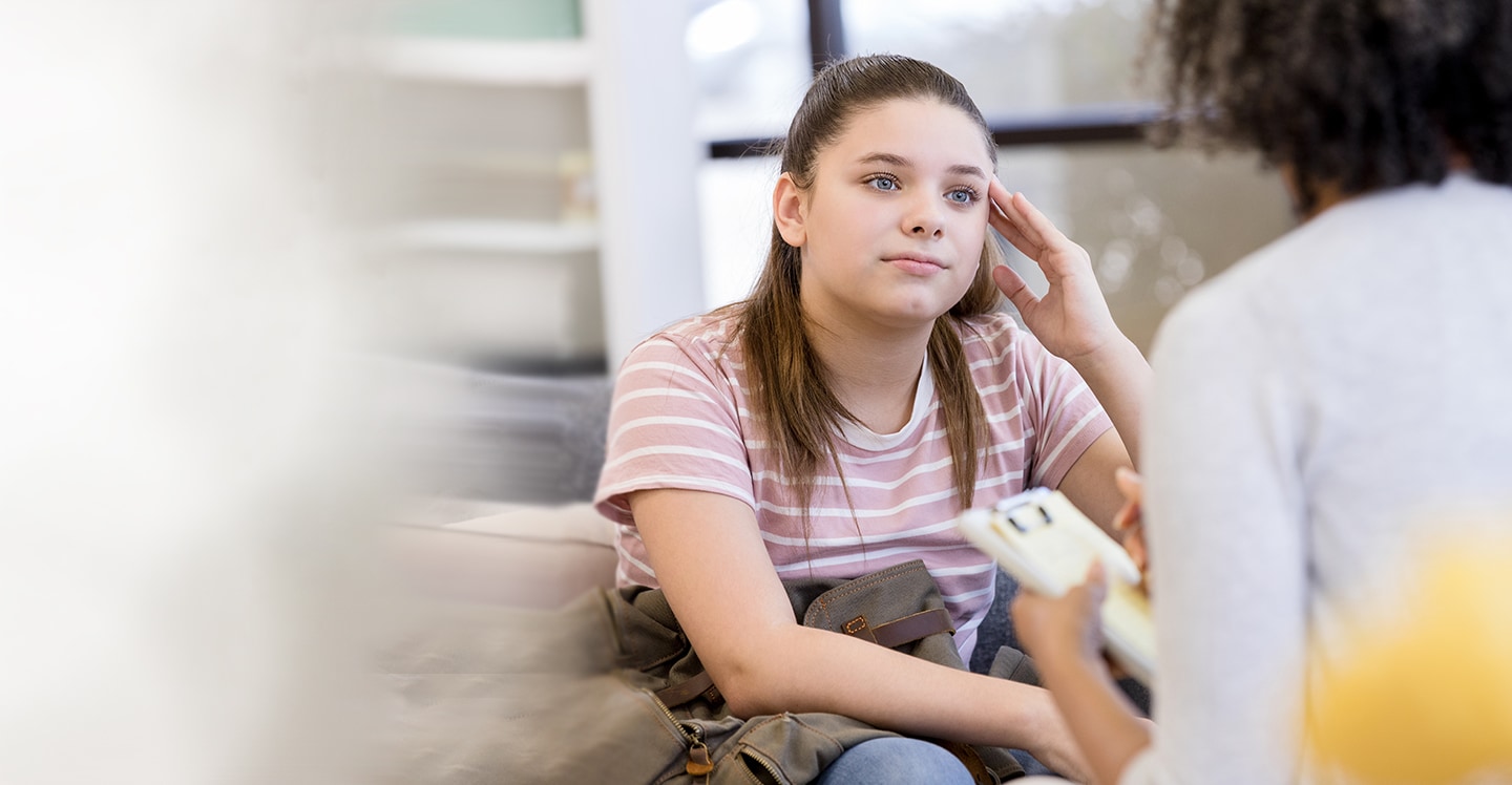 teen girl speaking to counselor