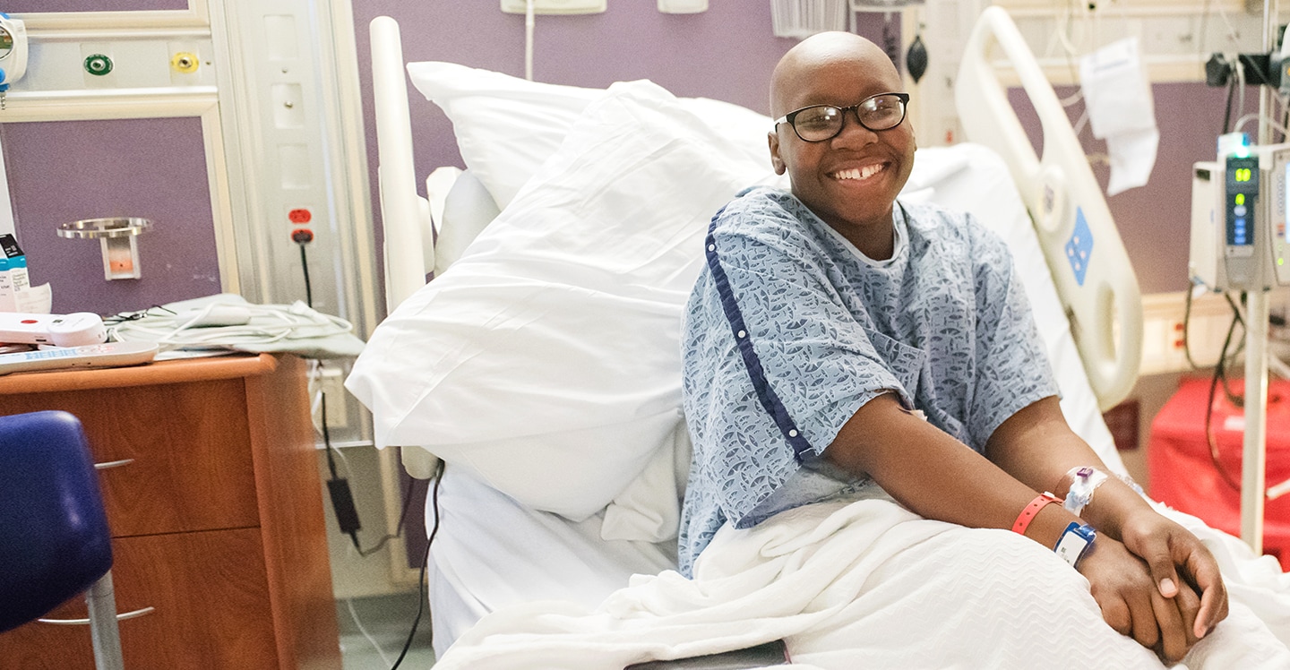 teen bone marrow transplant patient smiling in hospital bed