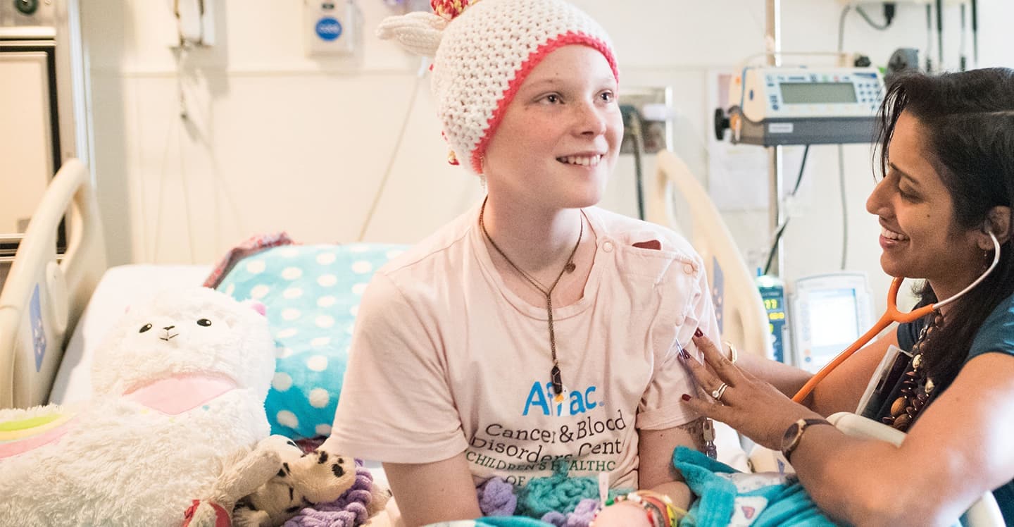 Cancer doctors visits patient girl in hospital room for checkup