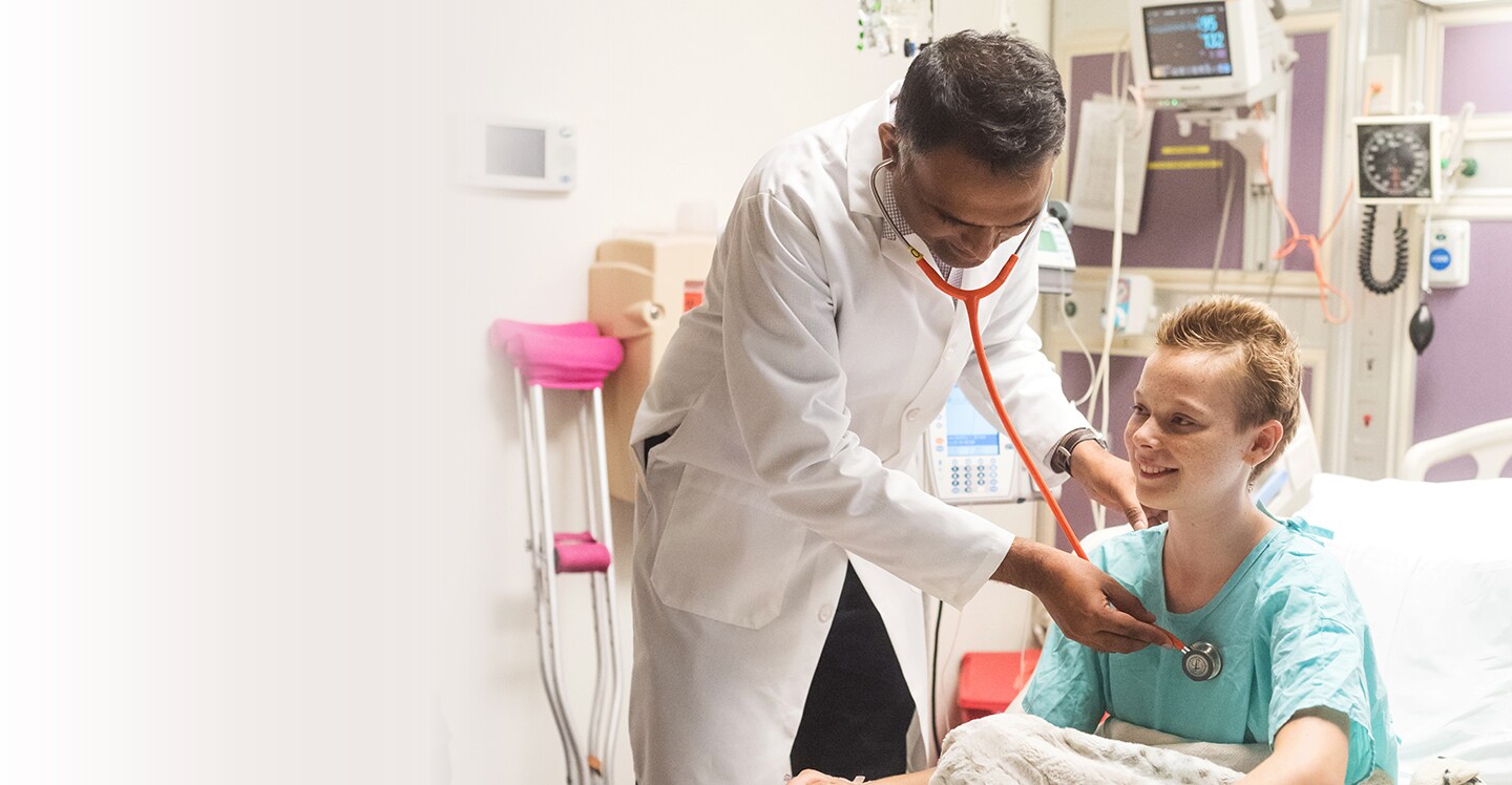 Dr. Chandrakasan checking female cancer patient
