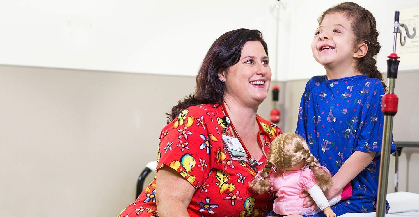 Young patient with craniofacial disorder laughing with Children’s Healthcare of Atlanta nurse