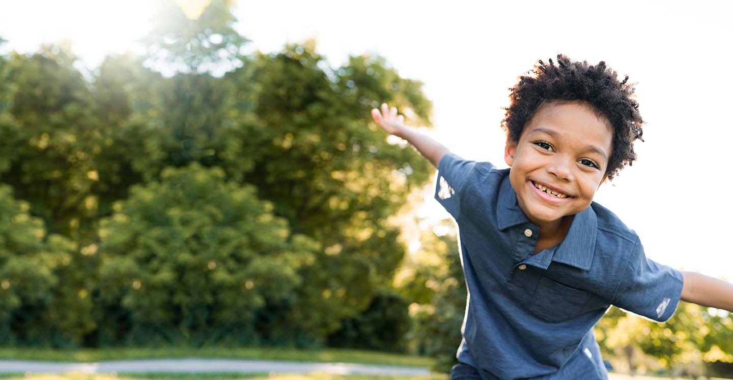 Child smiling outside