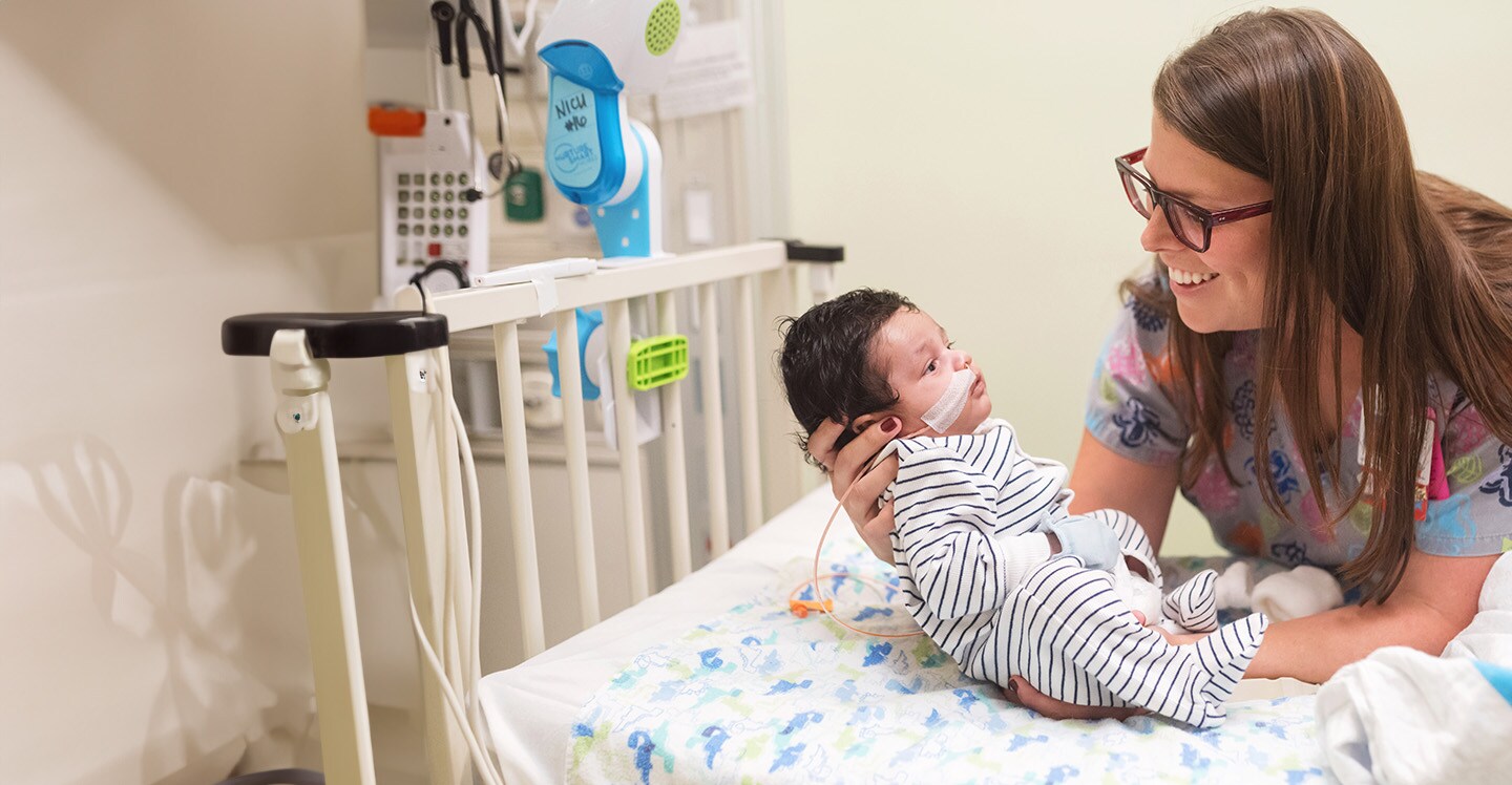 Neonatal intensive care nurse with baby patient in the hospital.