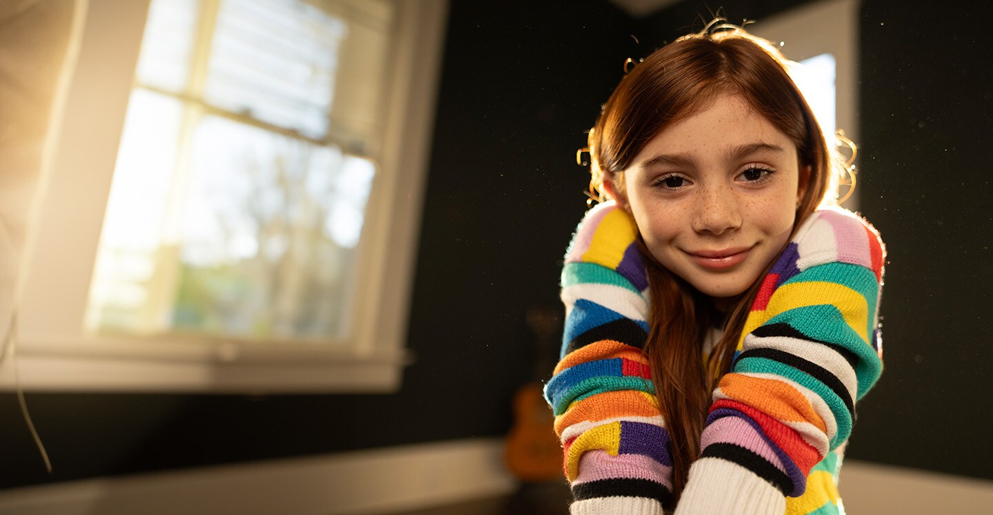 Girl with arrhythmia smiling at home