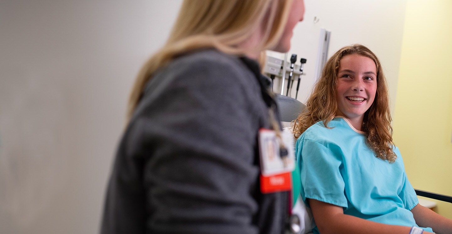 Nurse treating a teen patient in a clinic setting