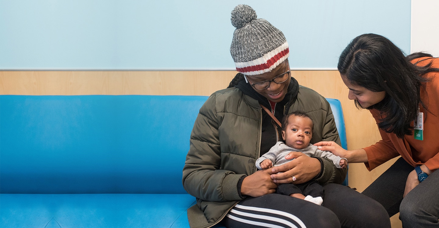 Doctor meeting with an infant and parent