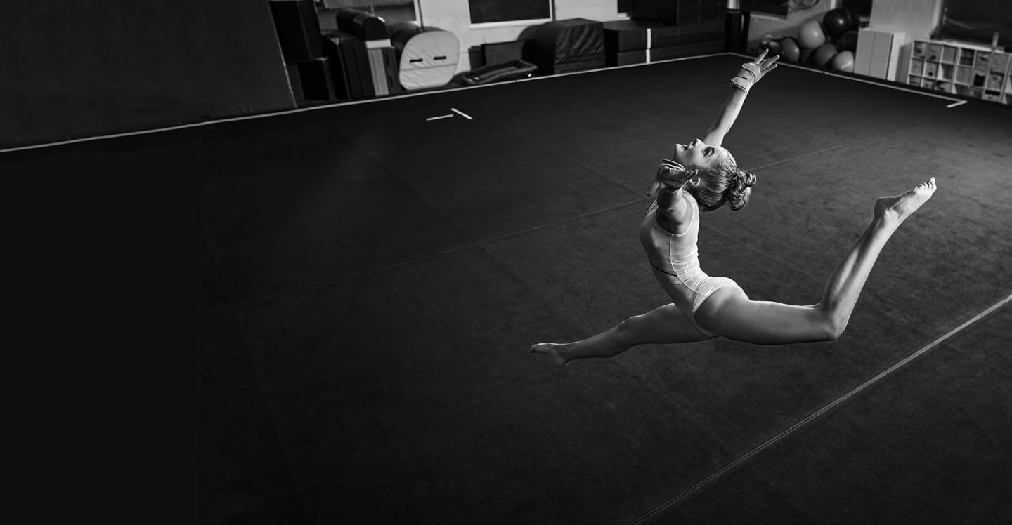 Teen patient and gymnast bending backward during floor routine. 