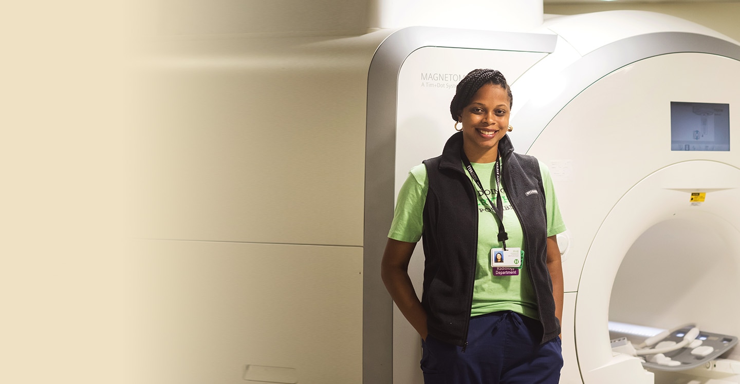 Pediatric radiology team member prepares MRI machine.