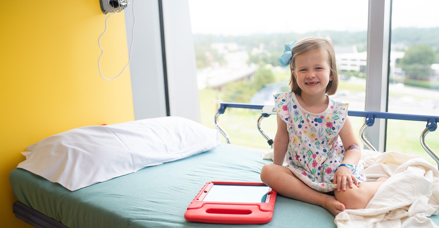 Pediatric patient on hospital bed preparing for treatment.