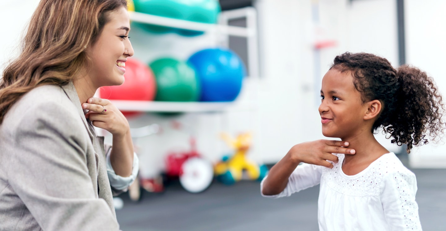 Therapist works with child during speech therapy