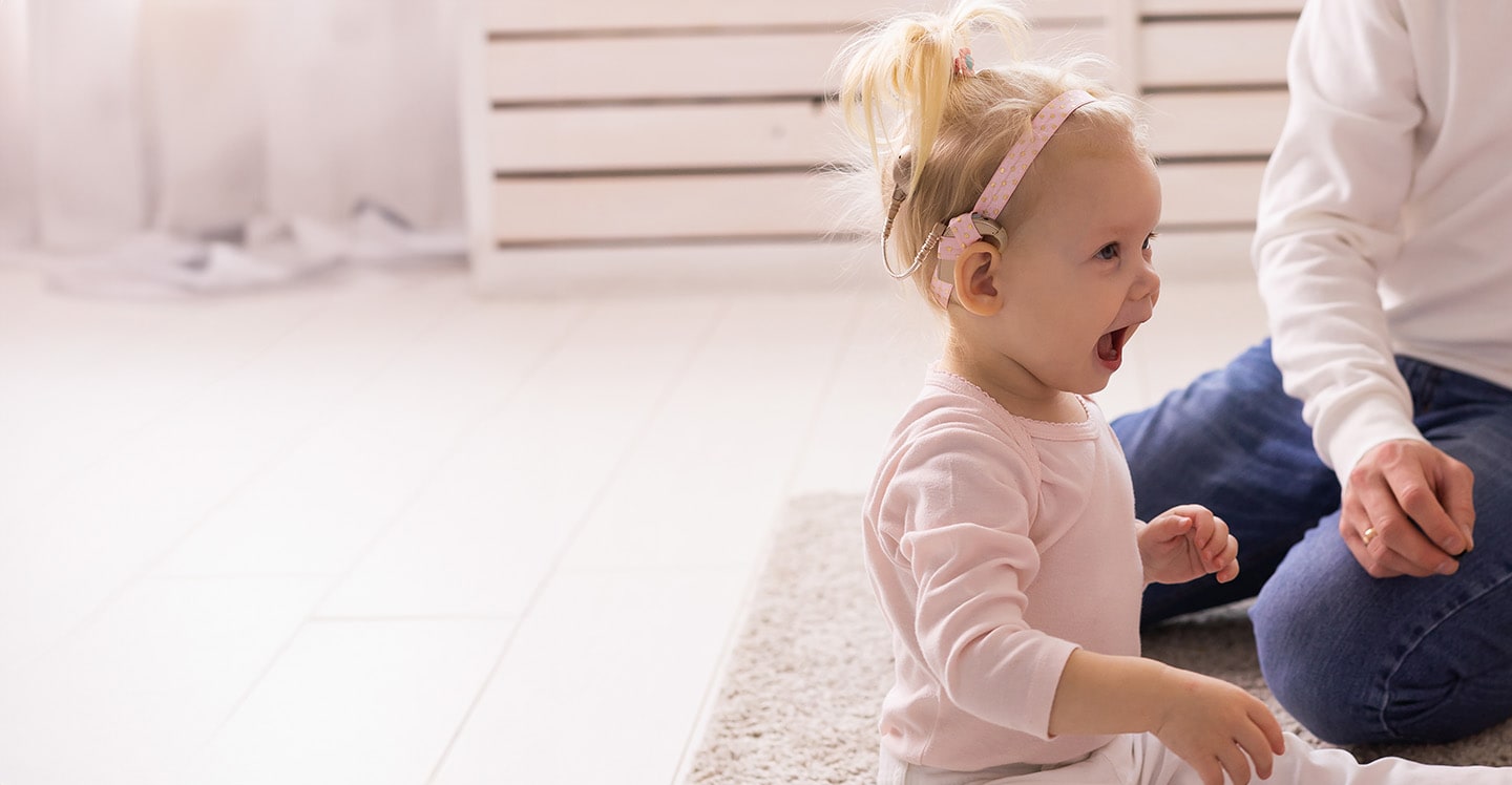 Toddler with cochlear implant playing.