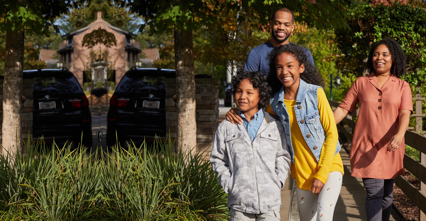 Family walking down a sidewalk