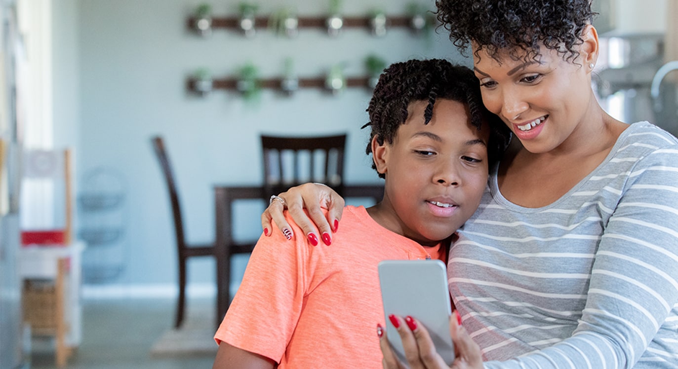 Mom and son having a telemedicine appointment on mobile phone