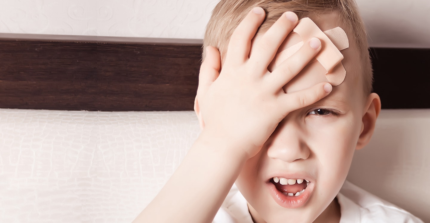 Boy with band aid on head