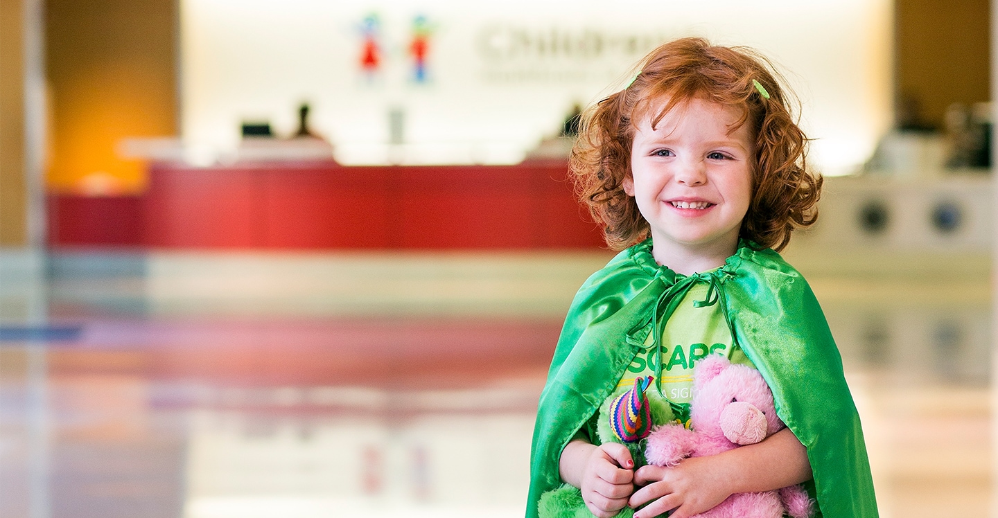 Girl smiling in pediatric hospital lobby