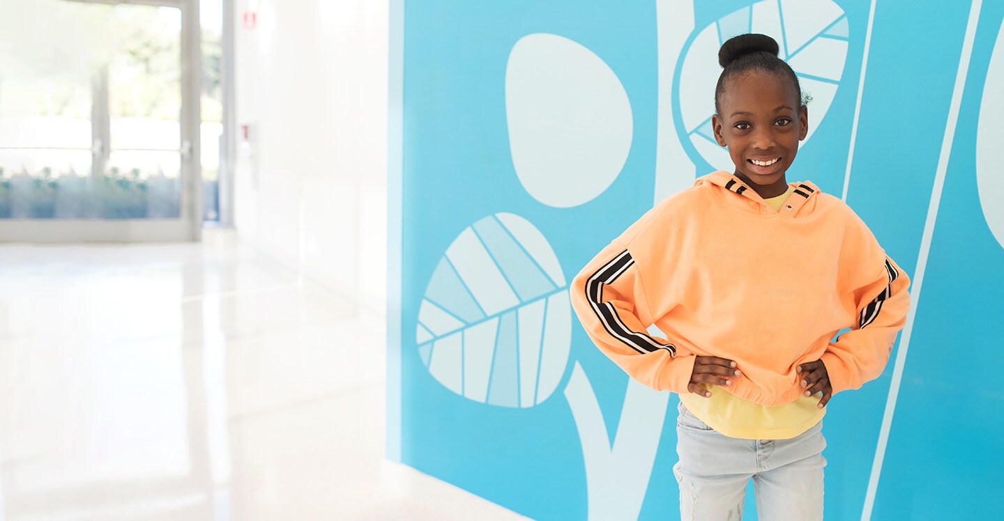 Smiling girl in hospital lobby