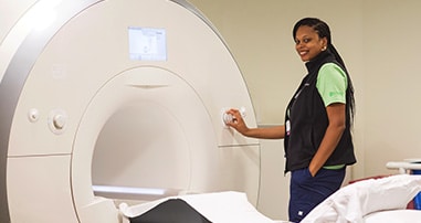 Pediatric radiology team member prepares MRI machine.
