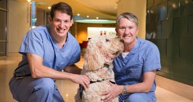 Doctors smiling with dog
