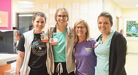 nurses smiling at pediatric hospital nurses station