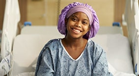 Child smiling in hospital bed