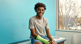 Orthopedics teen patient in arm cast