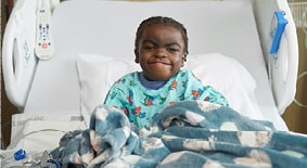 Transplant patient sitting in hospital bed