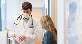 pediatric doctor reviewing handout with nurse