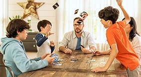 Boy getting upset while playing board game with family