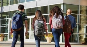 Group of teenagers walking into school
