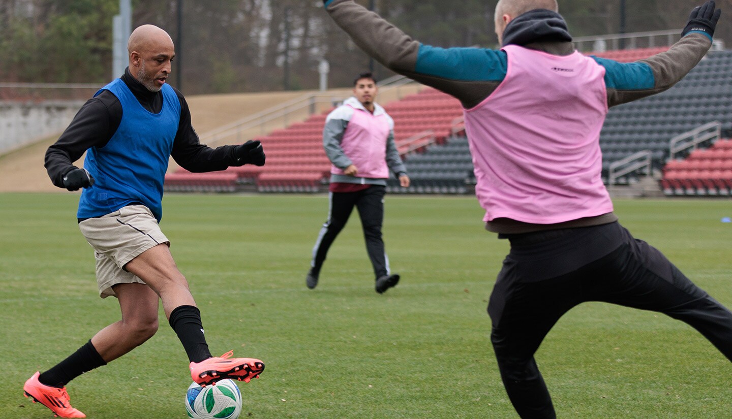Participant kicks a soccer ball during Atlanta United's Player for a Day event.