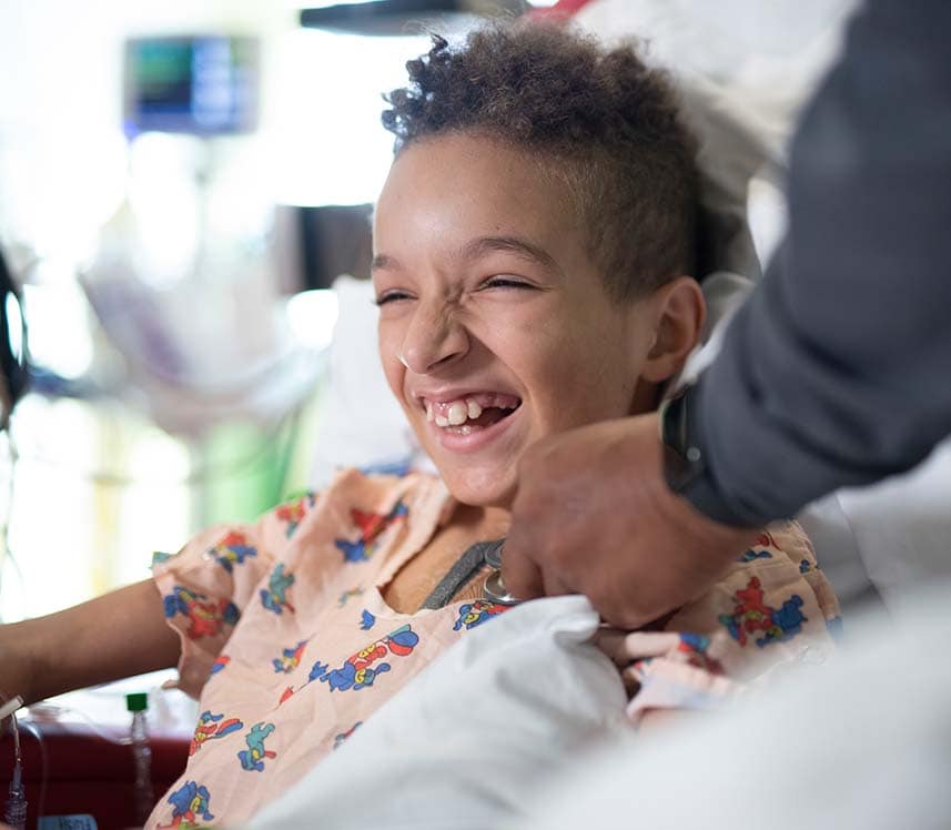 Pediatric heart patient boy laughing in hospital