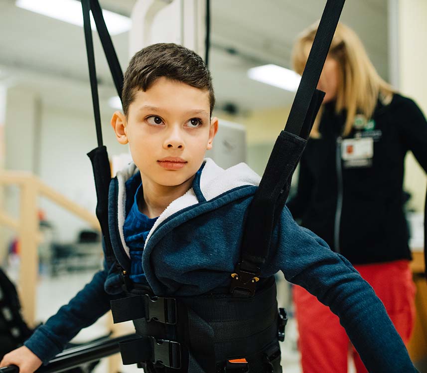 Boy receiving robotic therapy at the hospital