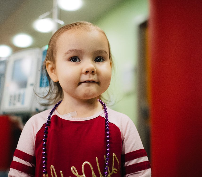 cancer patient showing her beads at Children's hospital