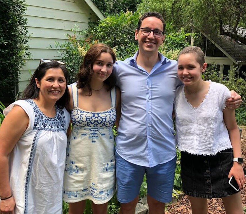 family smiling outside