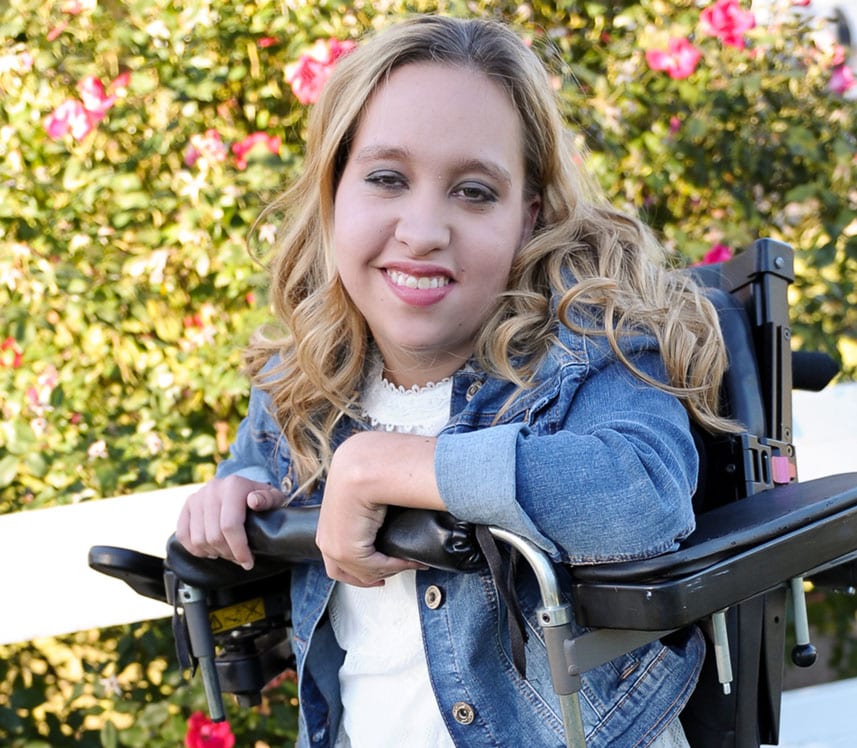 teen girl with cerebral palsy smiling in wheelchair