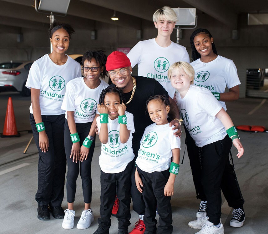 Children's Healthcare of Atlanta patients smiling and posing with NE-YO as part of the Never Settle Challenge