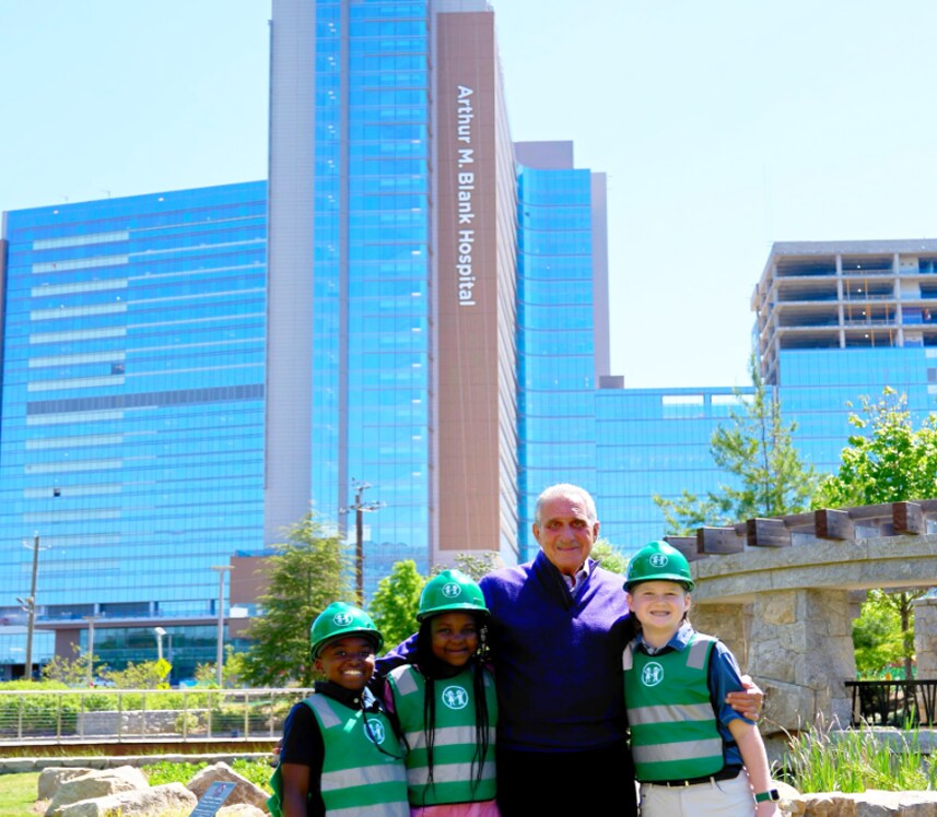 Arthur Blank and honorary construction managers in front of hospital