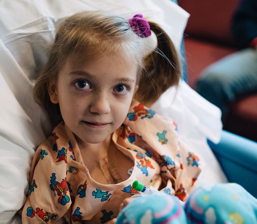 girl proudly shows her scars from cardiac surgery at pediatric hospital
