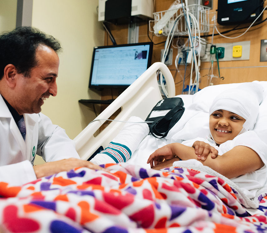 pediatric neurology doctor visiting his patient in her hospital room
