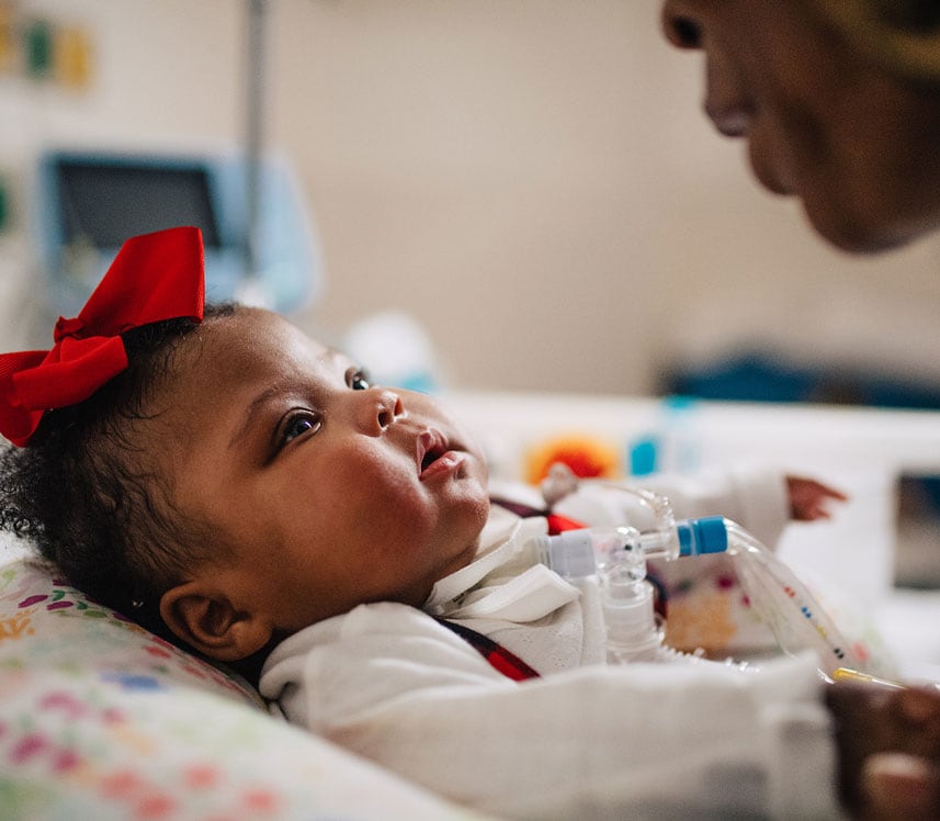 caregiver with baby girl at pediatric hospital