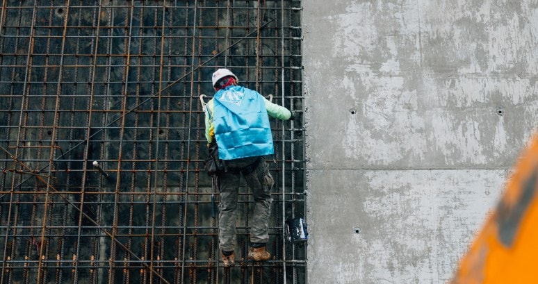 A construction worker climbs structure of new pediatric hospital