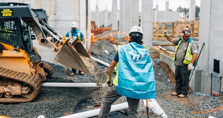 Construction workers wear capes at new pediatric hospital site