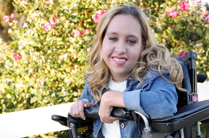 teen girl with cerebral palsy smiling in wheelchair