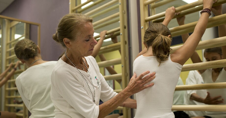 physical therapist performing schroth method on teen scoliosis patient