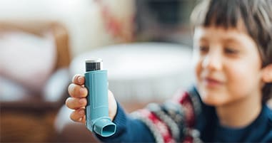 Boy using how to use asthma inhaler