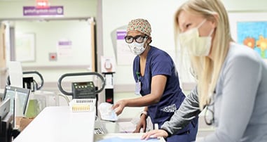 Nurses at desk in masks